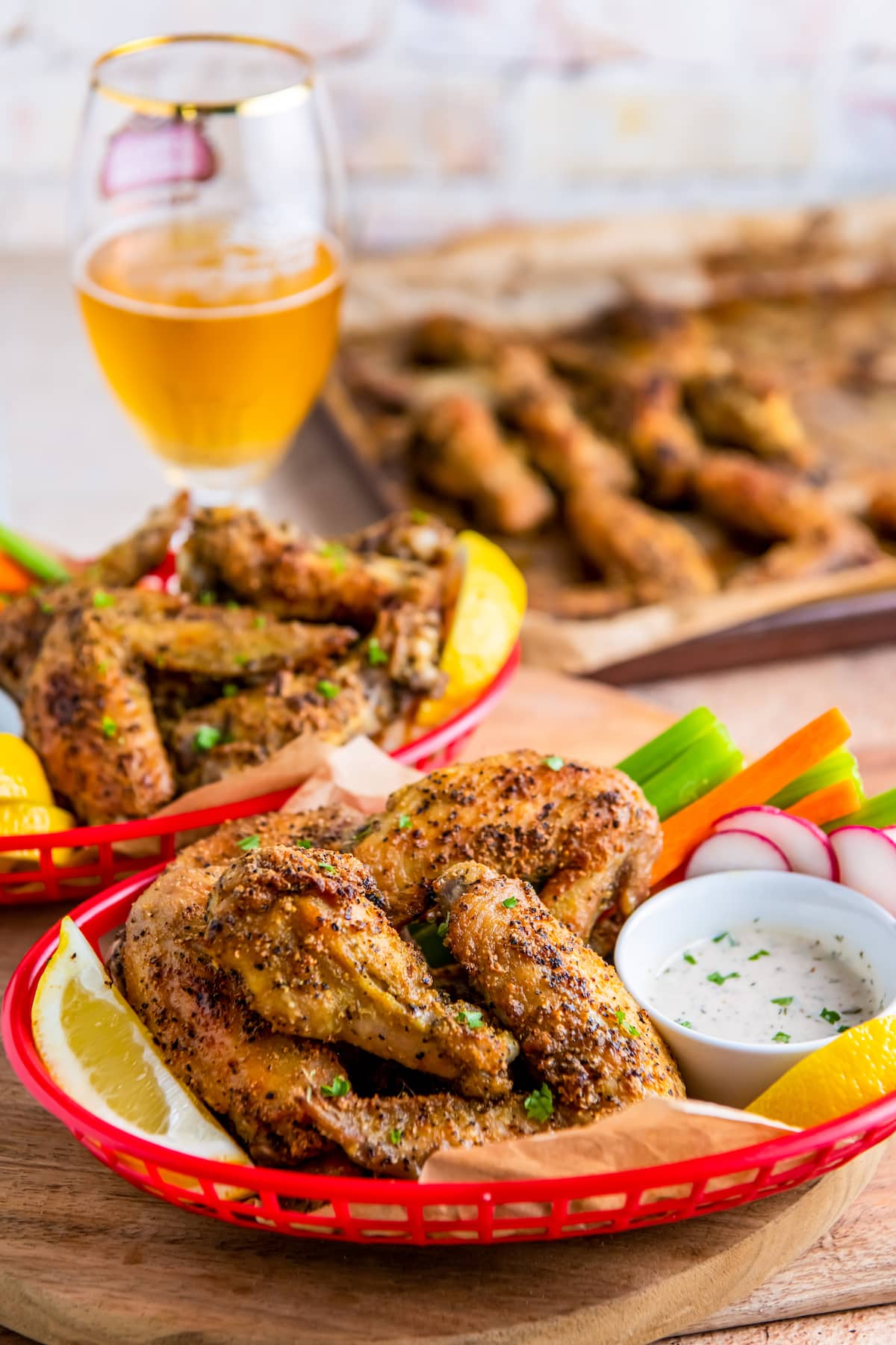 chicken wing platters with dipping sauce and vegetables on the side