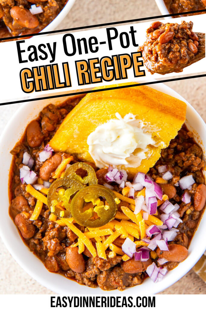 A bowl of beef chili topped with buttery cornbread, cheese, jalapenos and onions.