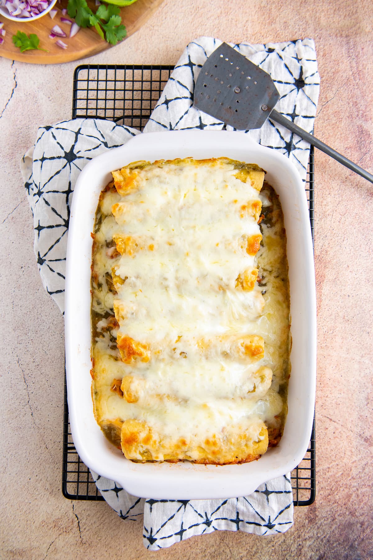 casserole dish with baked salsa verde chicken enchiladas