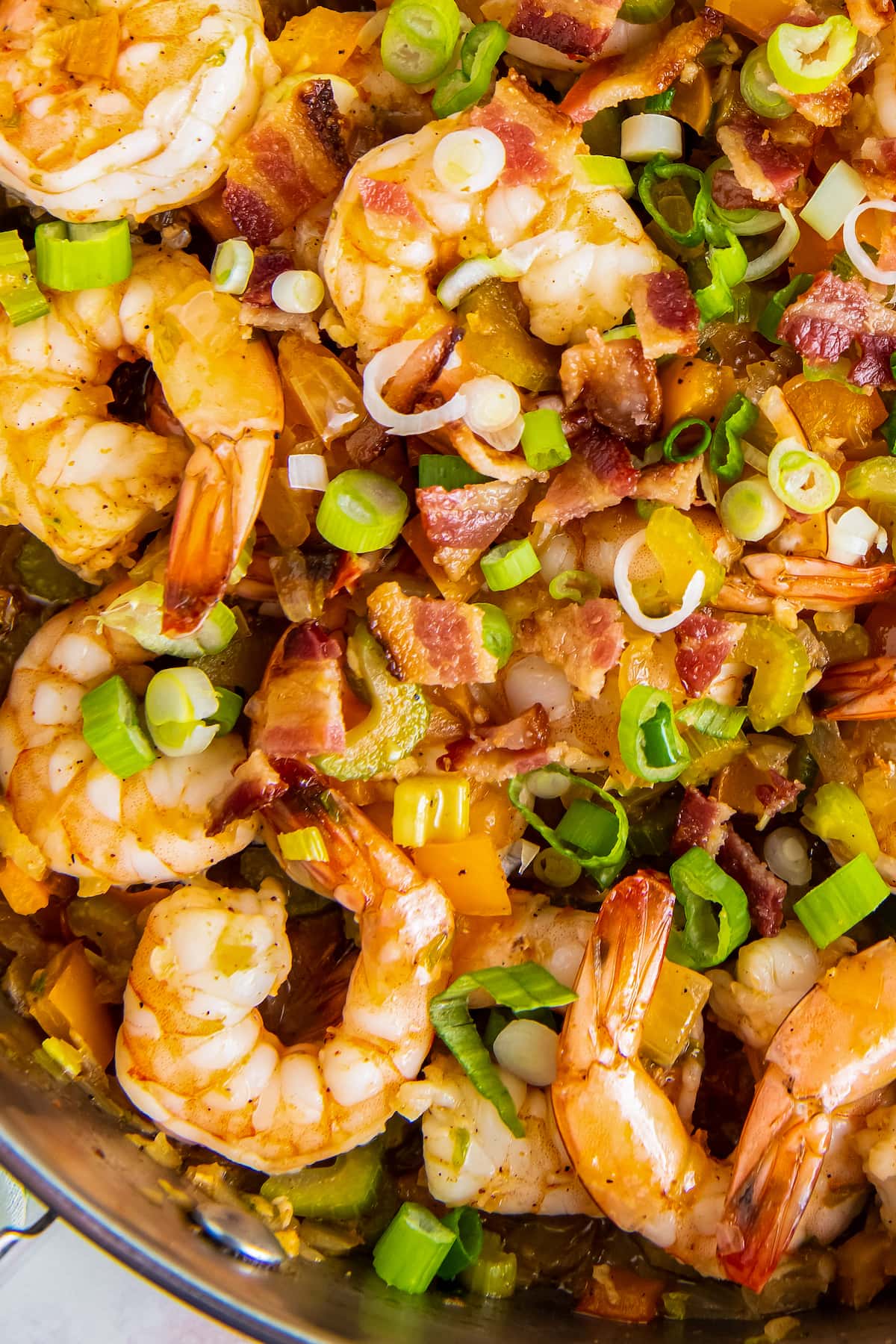 cooked shrimp with sliced green onions, bacon, and bell peppers