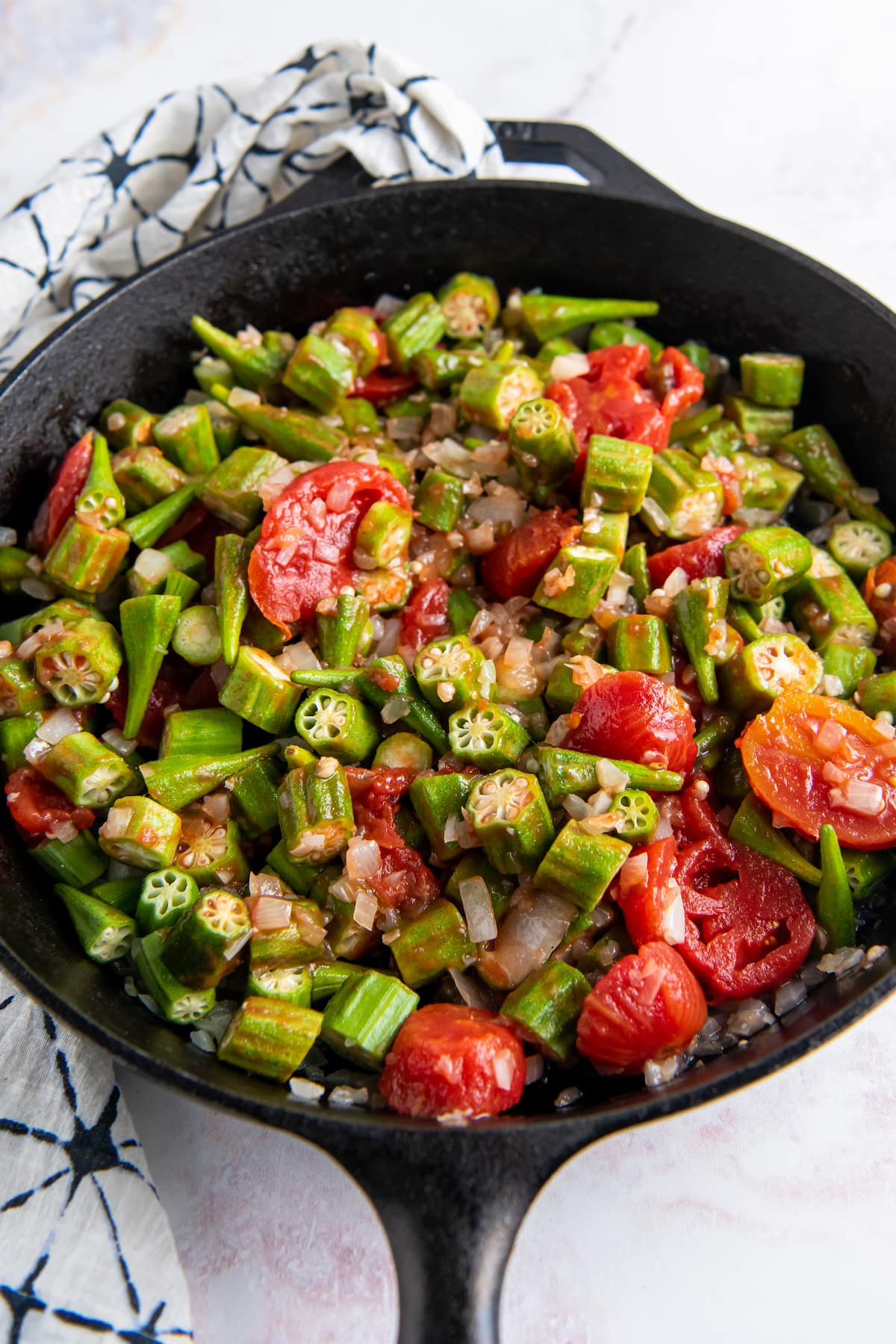 a skillet with chopped okra and tomatoes