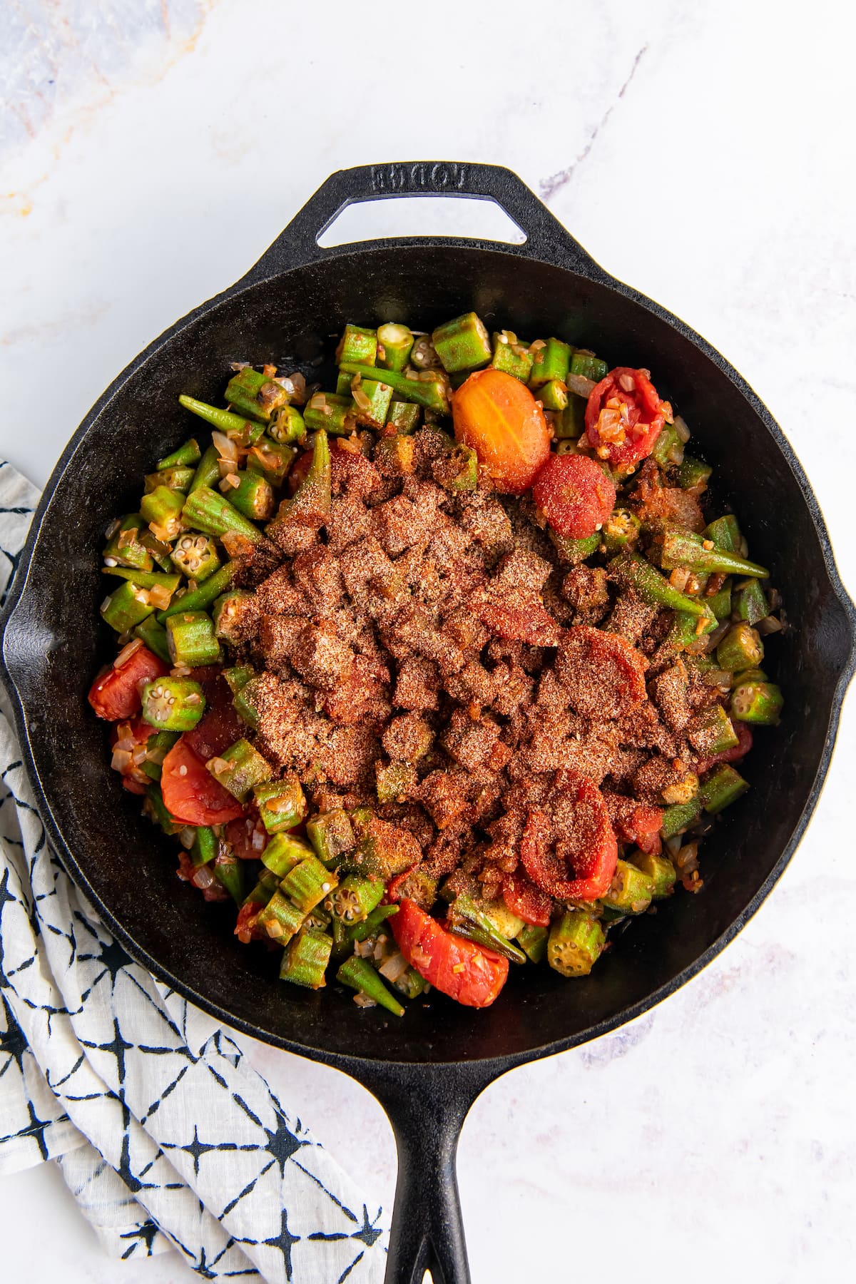a cast iron skillet with okra and tomatoes