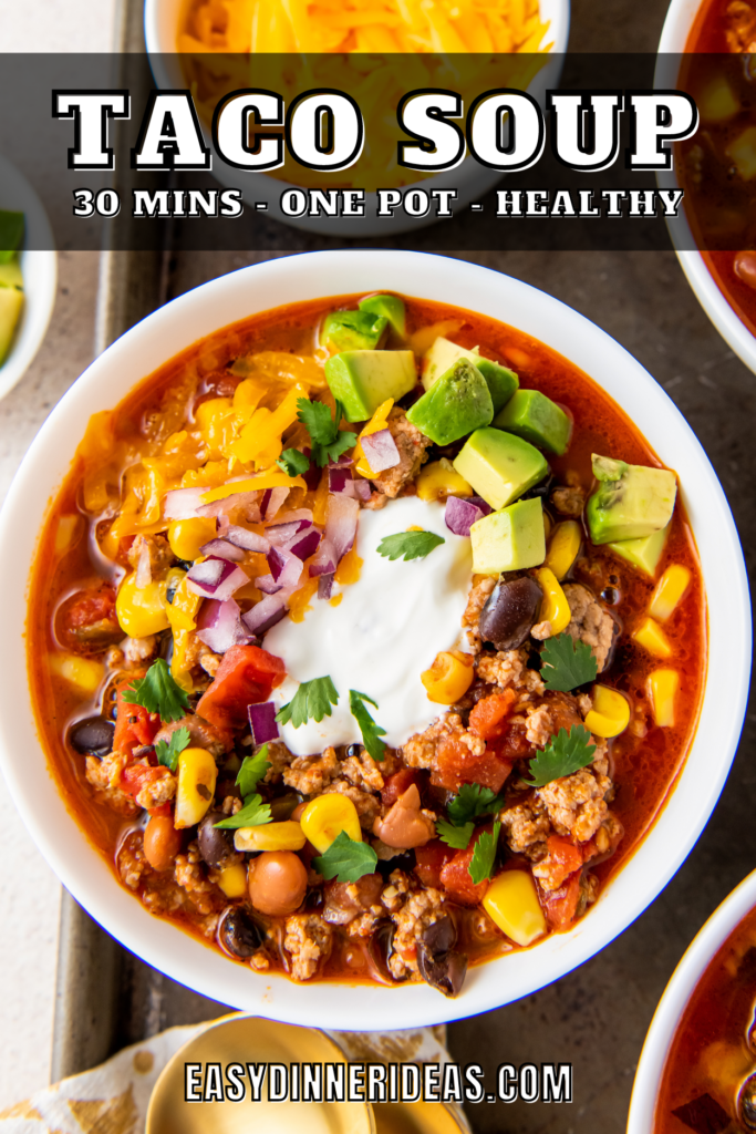 A bowl of taco soup with sour cream and cilantro on top.