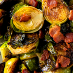 Bacon Brussels Sprouts on a plate with a spoon.