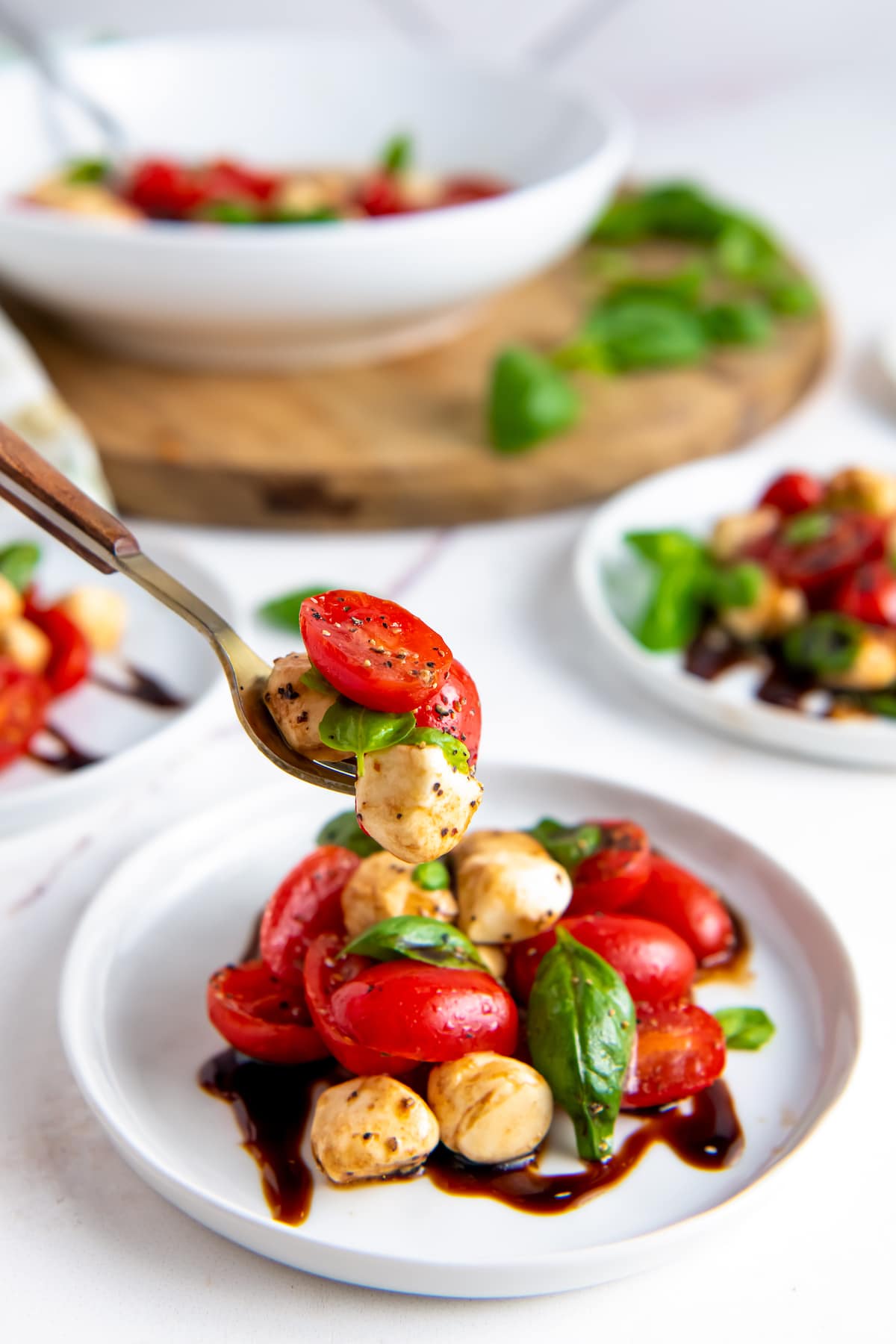 A bowl of caprese salad is ready to serve.