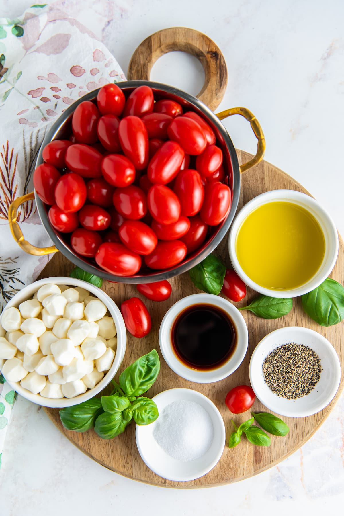 Ingredients ready to make caprese salad with cherry tomatoes.