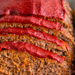 Slices of meatloaf with sauce.