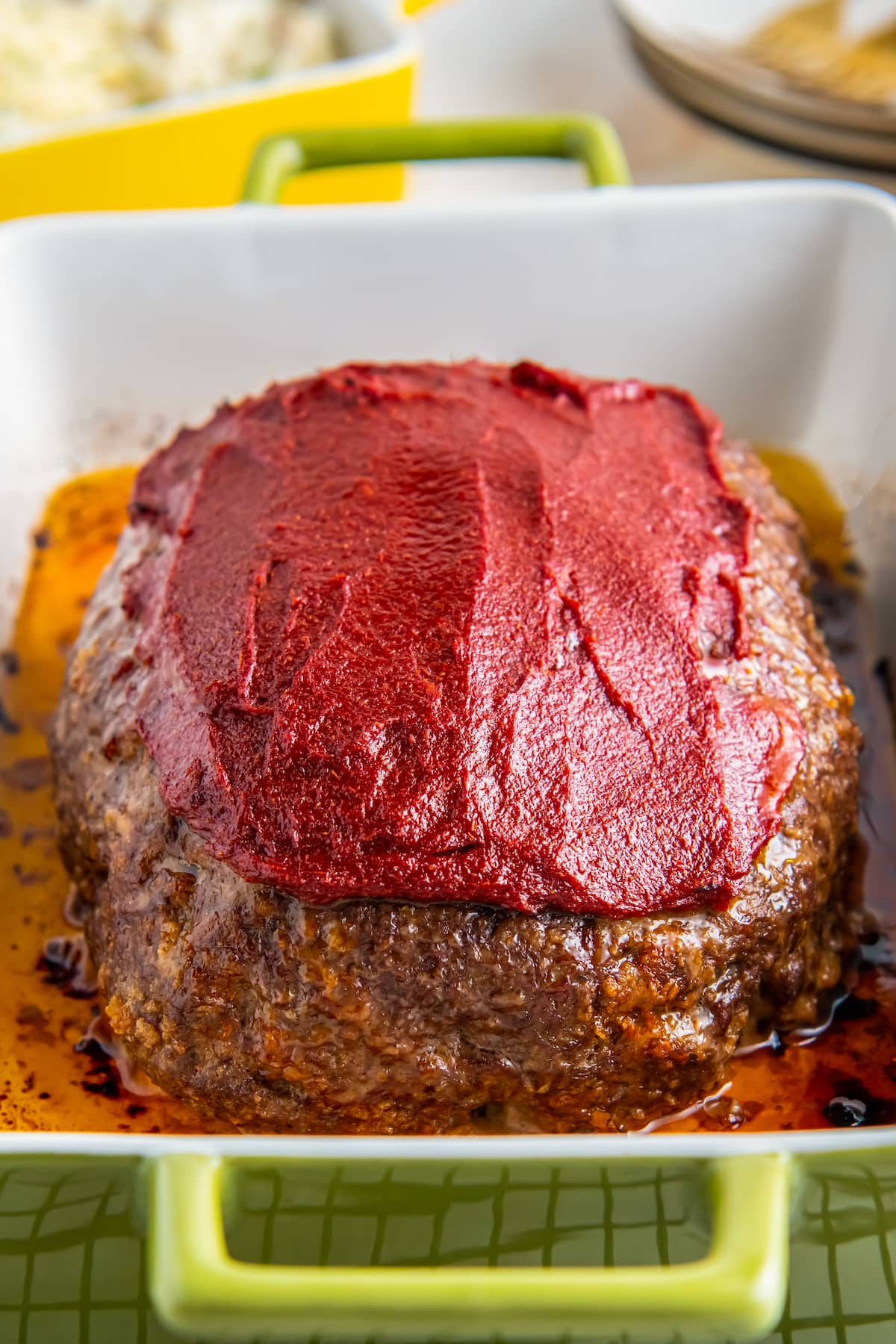 Meatloaf topped with sauce.