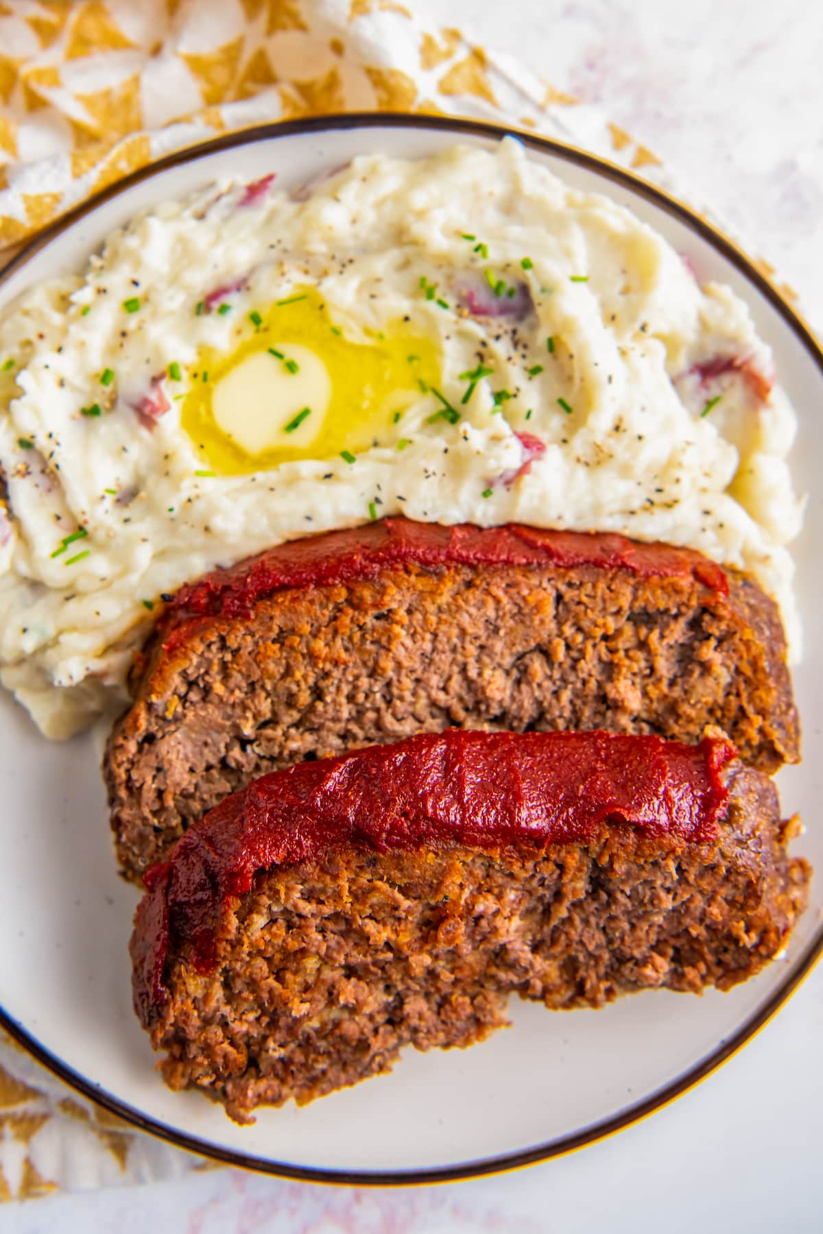 Slices of easy meatloaf and mashed potatoes.