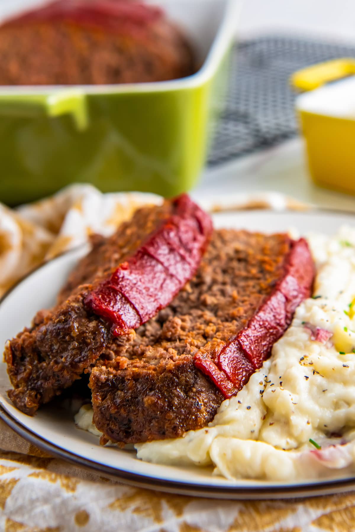 Slices of easy meatloaf and mashed potatoes.