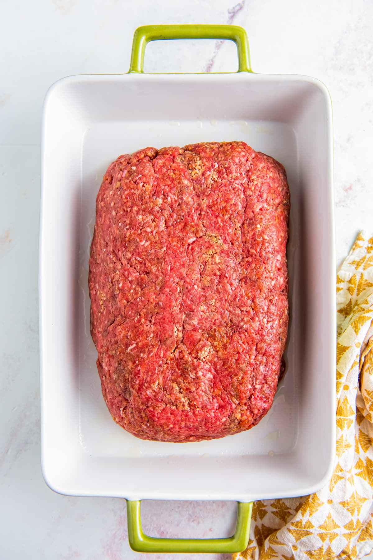 Meatloaf is placed in a loaf pan.