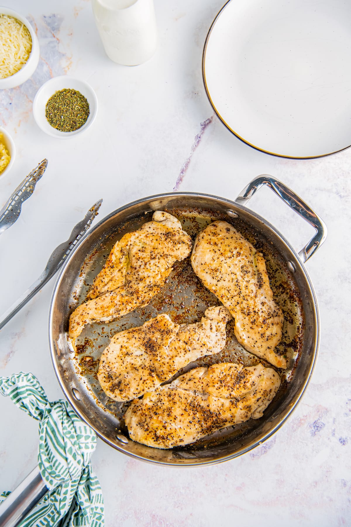 Chicken cooks in a skillet.