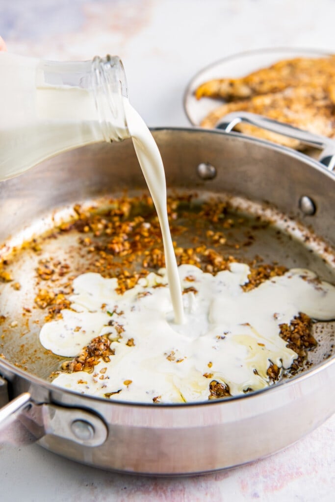 Cream is poured into a hot skillet.