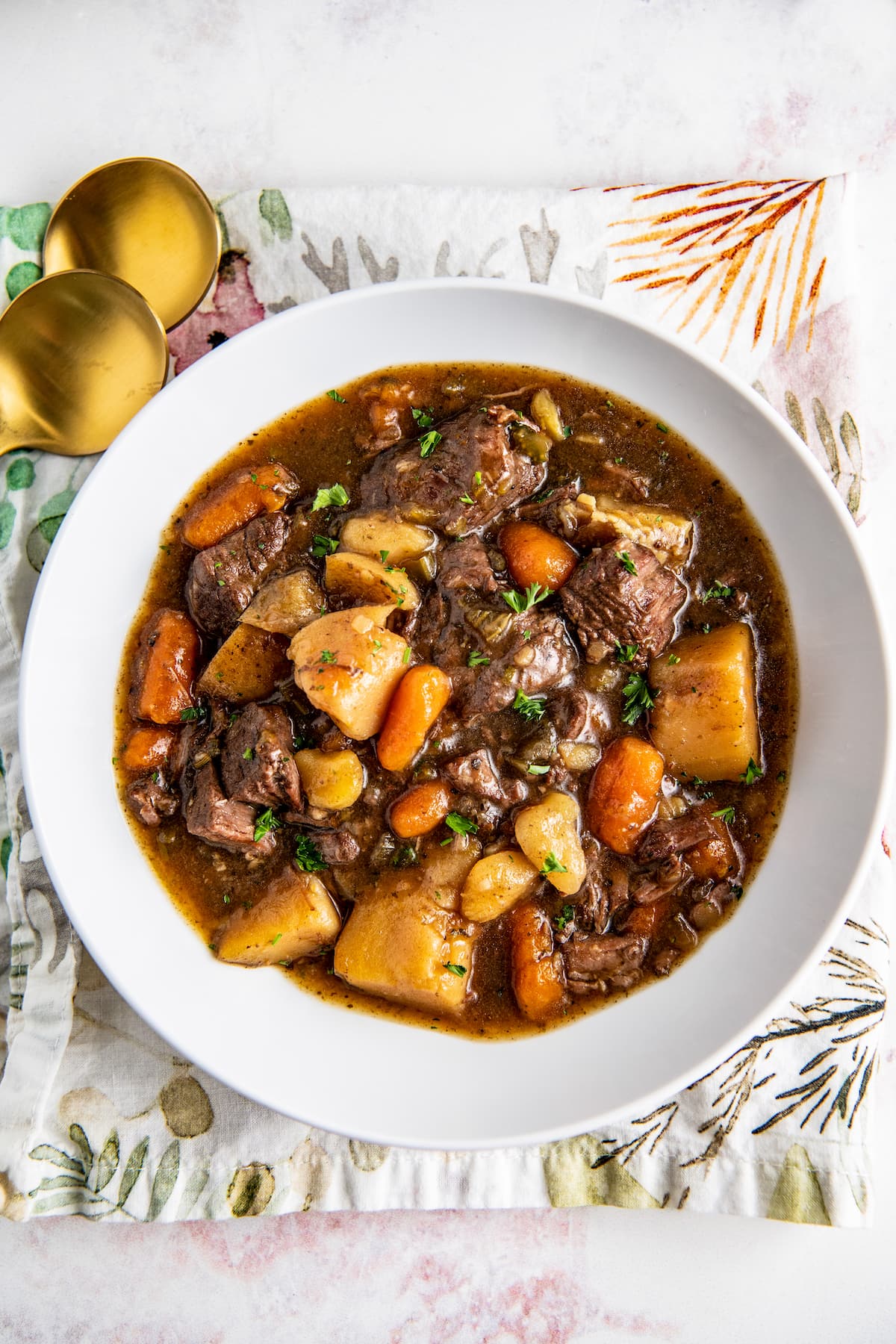 A bowl of beef stew that's loaded with carrots, potatoes, and stew meat.