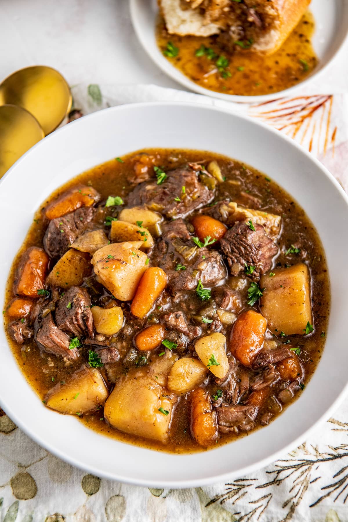 A bowl of beef stew that's loaded with carrots, potatoes, and stew meat.