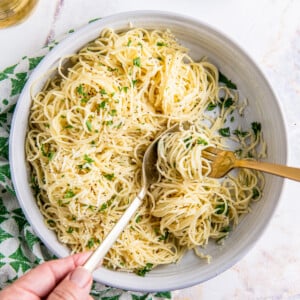 A bowl of buttery noodles is ready to eat.