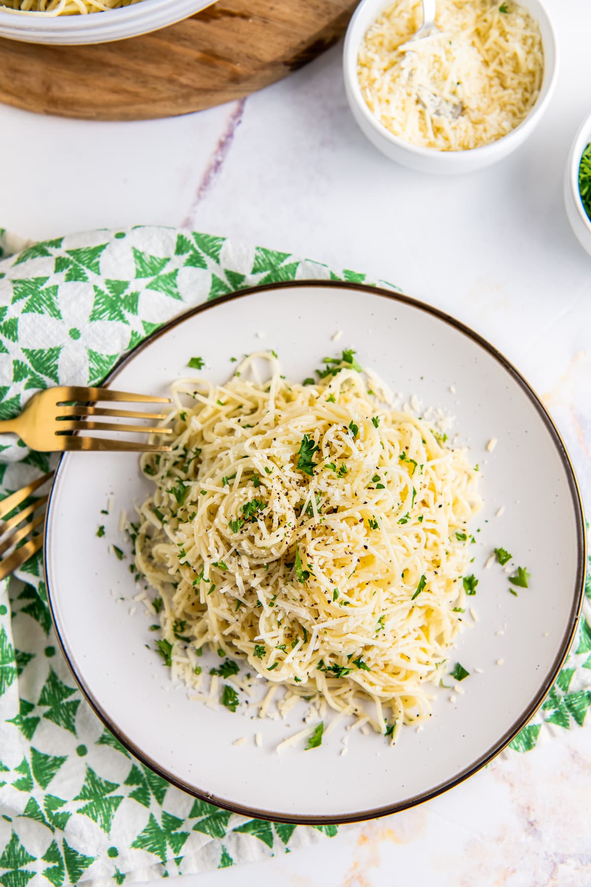 Parmesan butter noodles are seen on a plate with a fork.