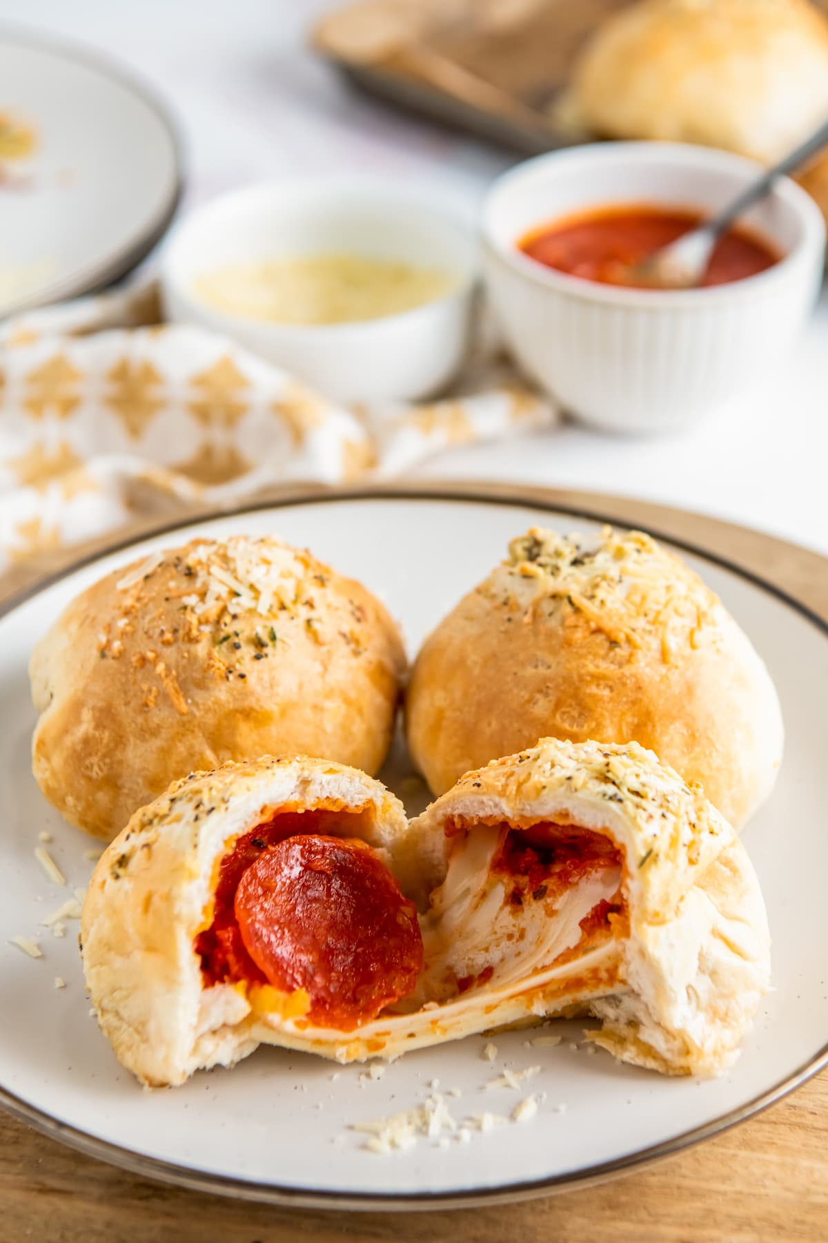 A plate of pepperoni pizza bombs with melted mozzarella.