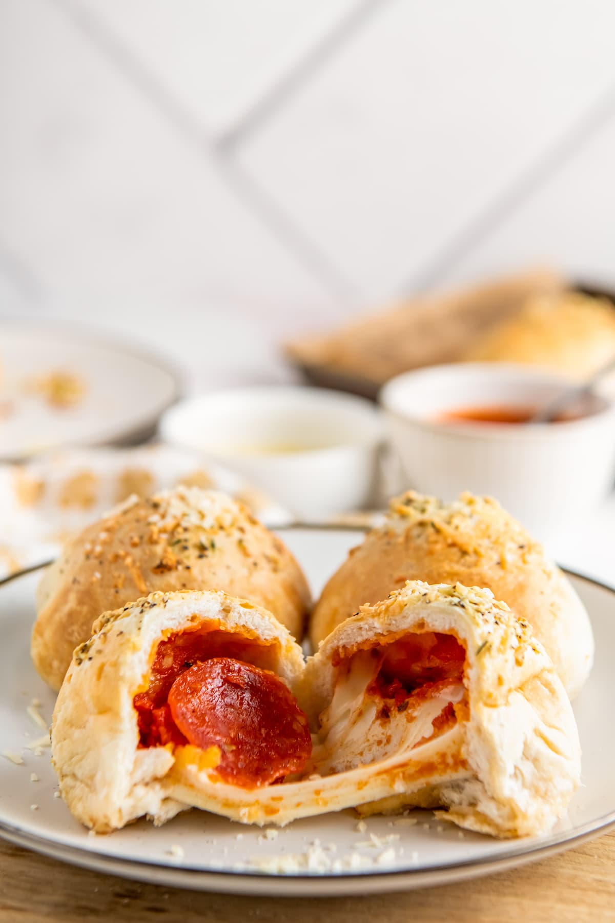A plate of baked pepperoni pizza bombs.
