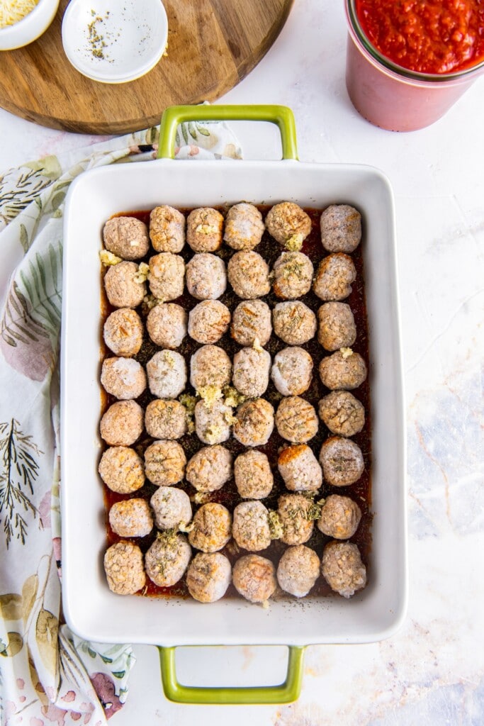 Frozen meatballs in a baking dish.