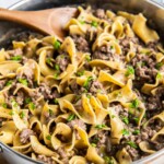 Beef and noodles in a skillet.