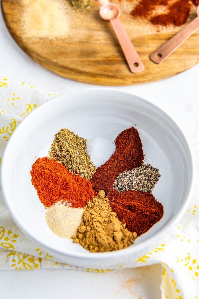 Chili powder, smoked paprika, ground chipotle, and more in a bowl.