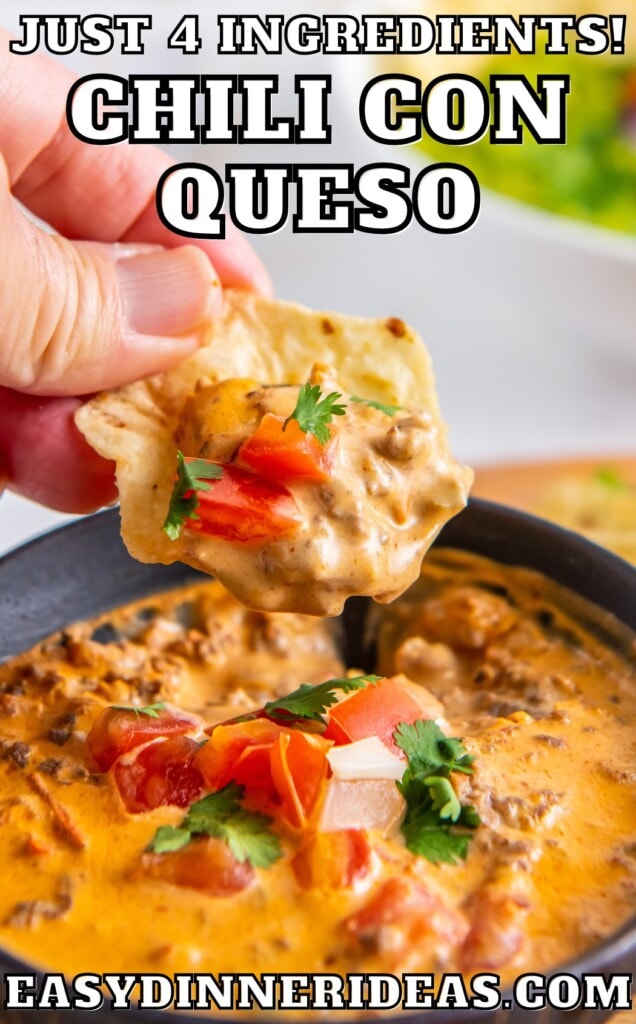A bowl of queso with a tortilla chip scooping up a bite.