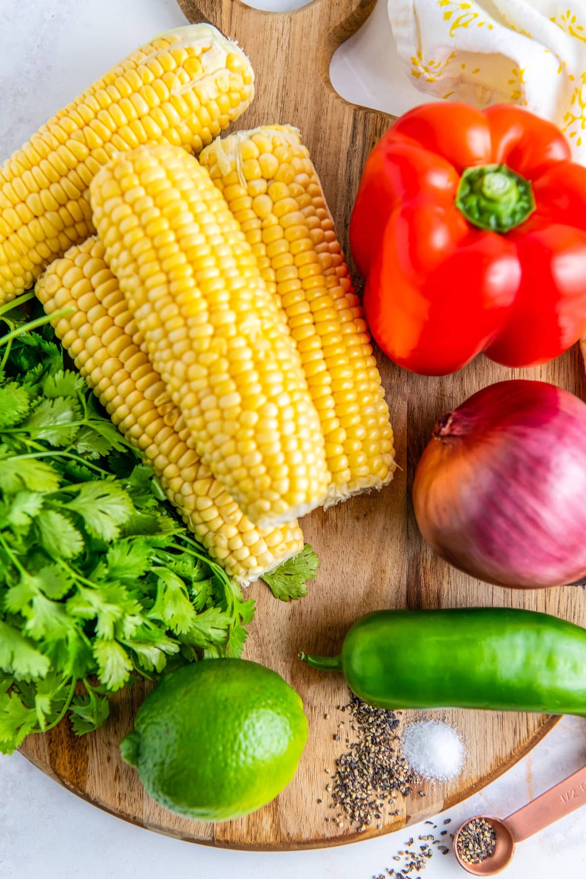 Ingredients for corn salsa on a cutting board.