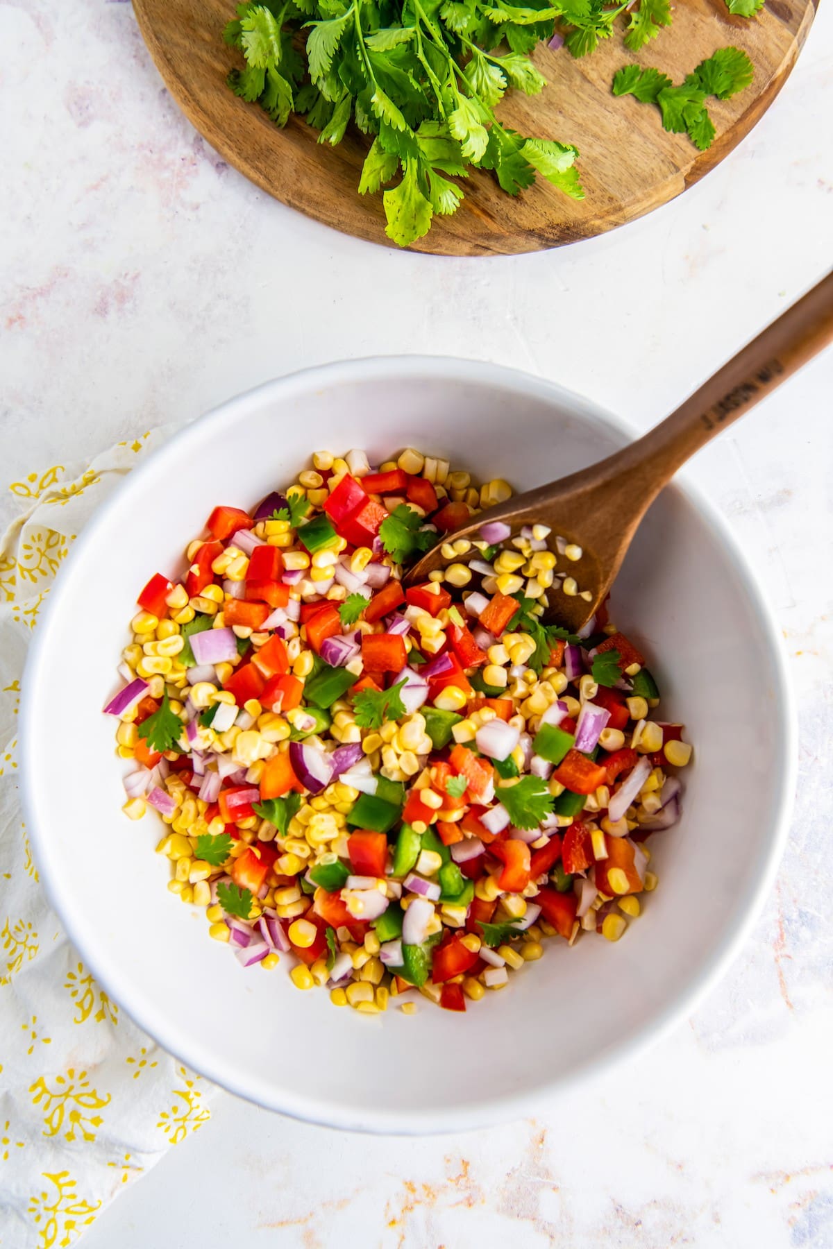 Corn kernels mixed with red onion and bell pepper.