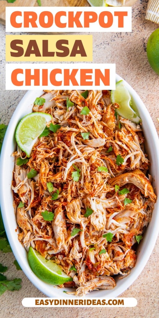 Slow cooker salsa chicken shredded with cilantro and lime wedges.