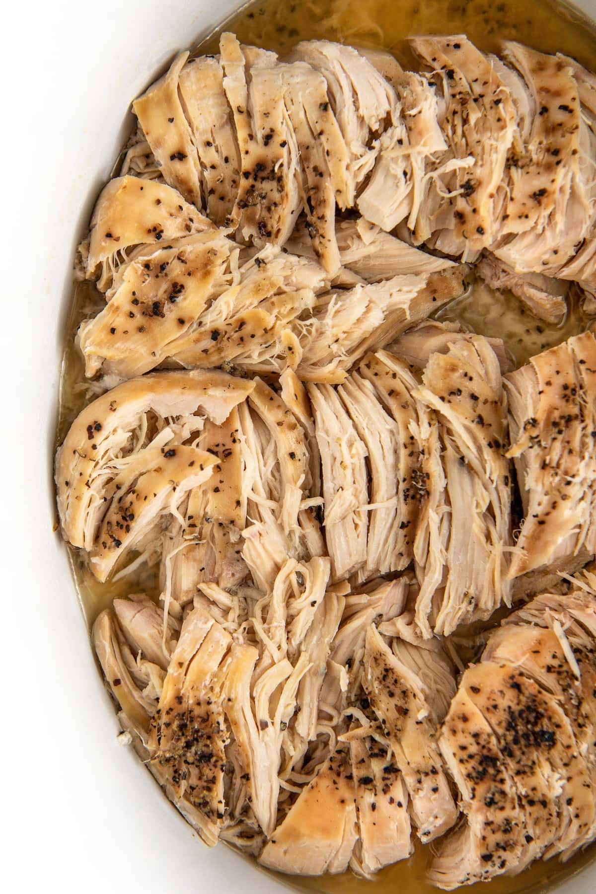 Pulled chicken seasoned with salt and pepper.