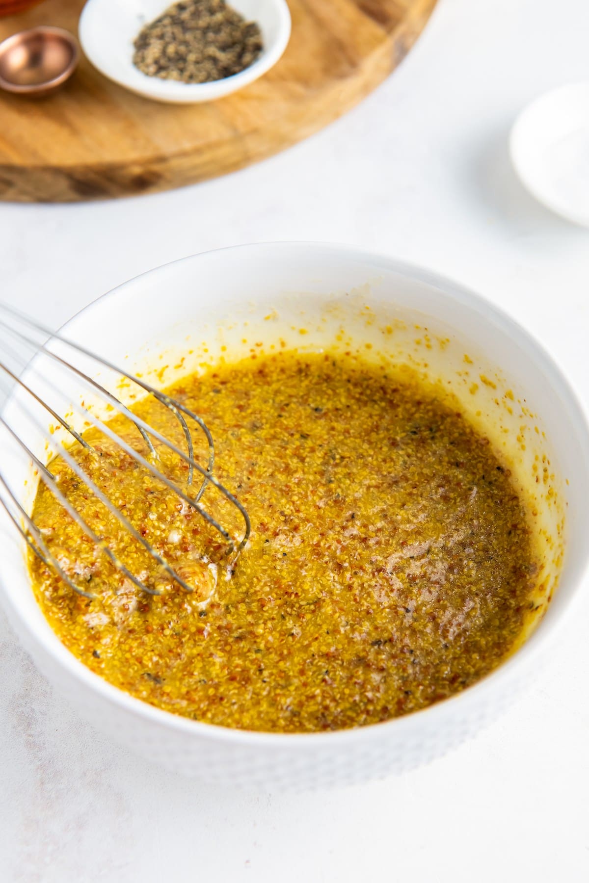 Honey mustard dressing whisked together in a bowl.