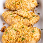 Baked chicken breasts coated in cracker crumbs.