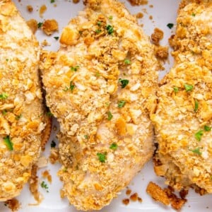 Breaded chicken breasts in a baking dish.