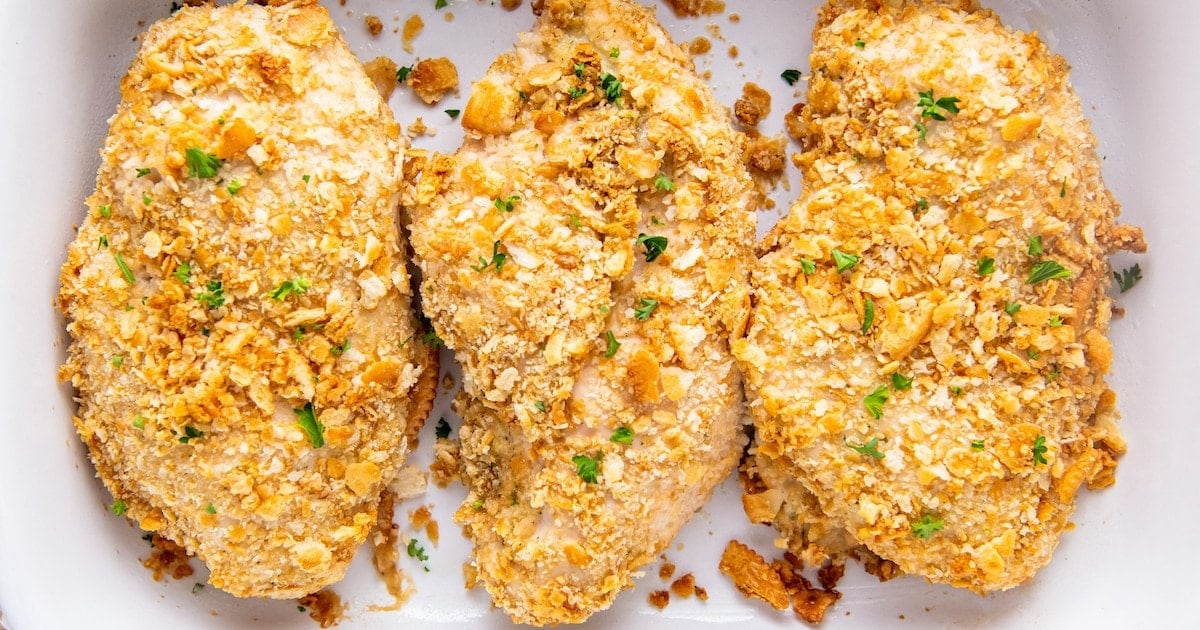Breaded chicken breasts in a baking dish.