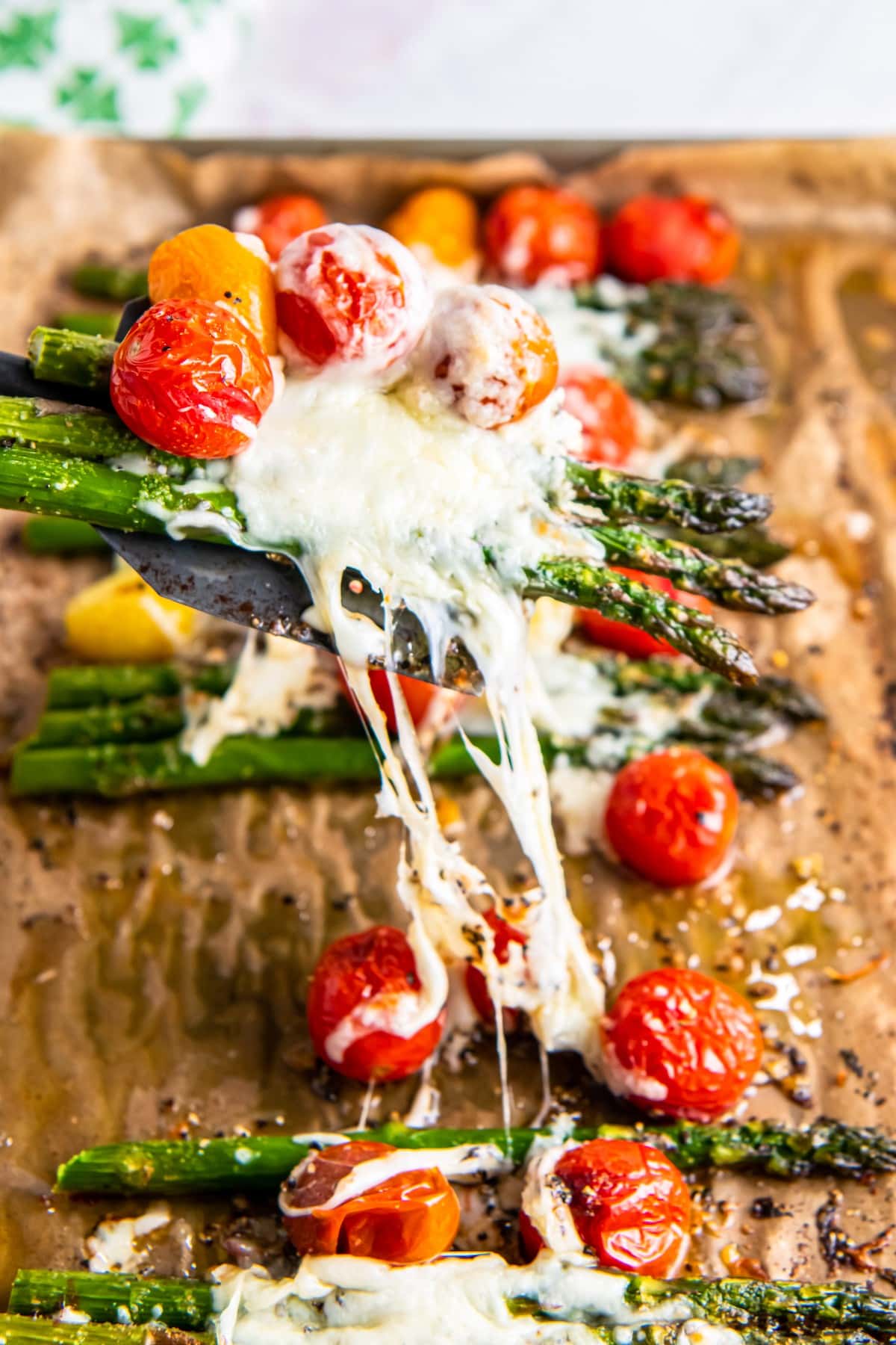 Mozzarella and parmesan melted over tomatoes and asparagus.