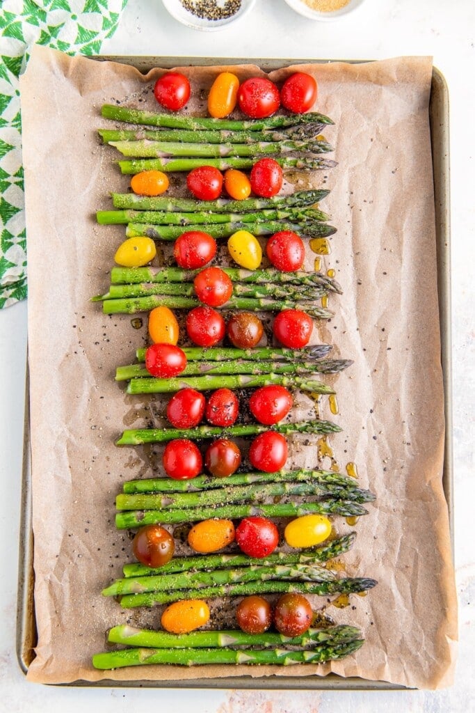 Seasoned cherry tomatoes and asparagus stalks.