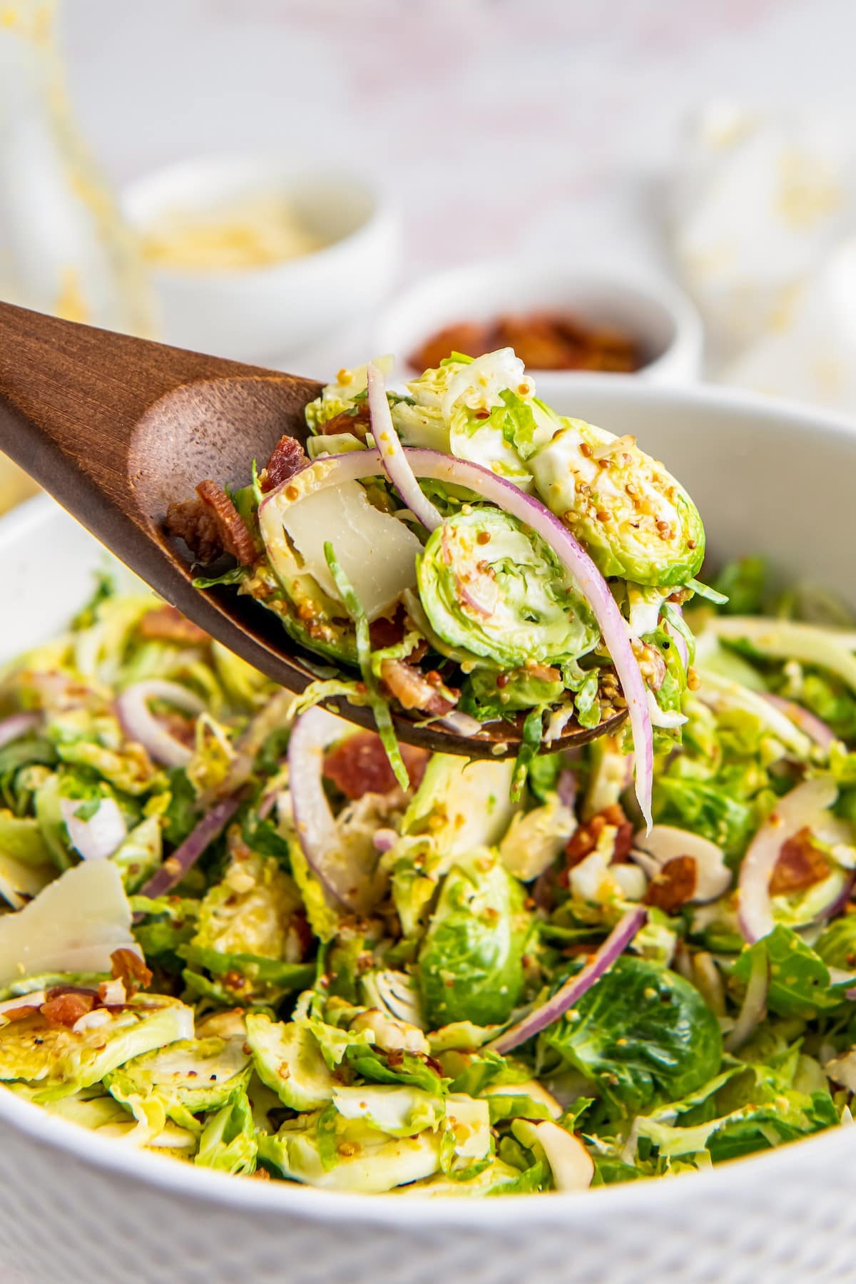 Shaved brussels sprout salad on a serving spoon.