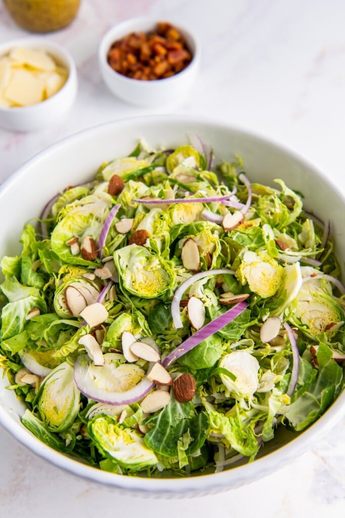 Brussels sprouts salad in a bowl with almonds.