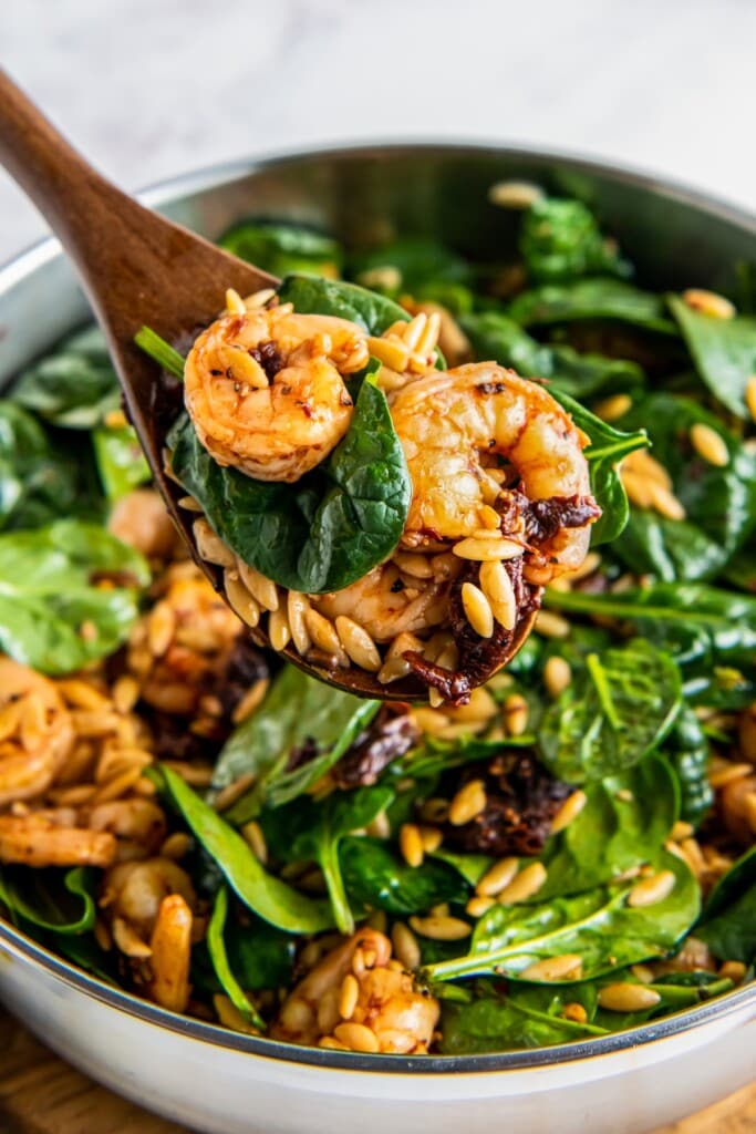 Sautéed shrimp with orzo and spinach.