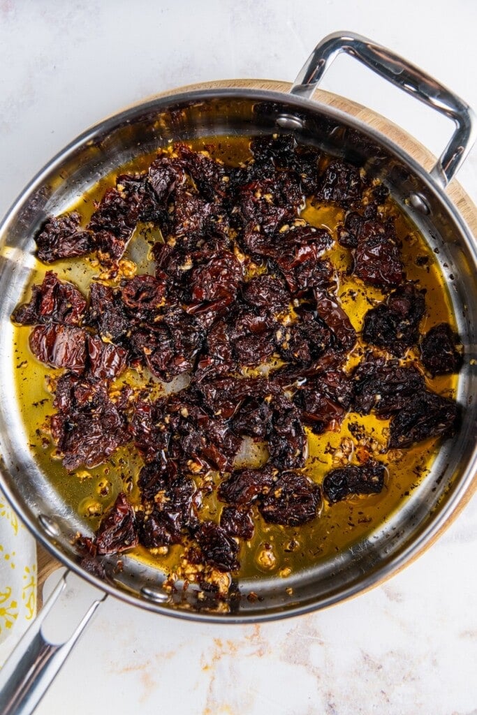 Sun-dried tomatoes cooking in olive oil.