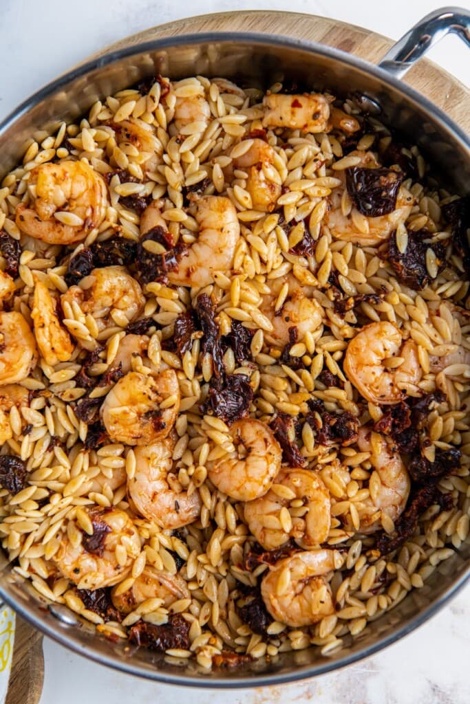 Orzo and shrimp mixed with sun-dried tomatoes.