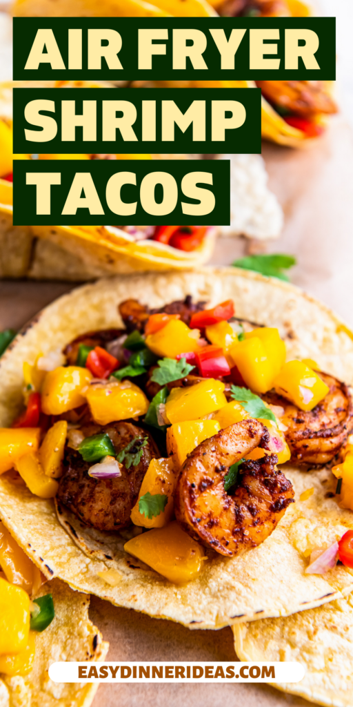 Shrimp tacos with fresh mango salsa stacked on a platter.