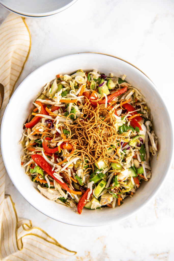 Chow mein noodles added on top of an Asian chicken salad.