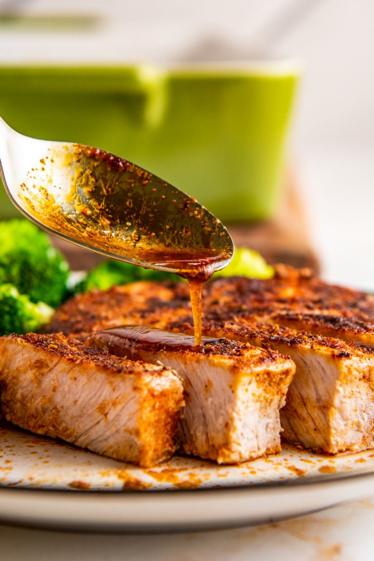 Baked pork chops with smoky seasoning on top.