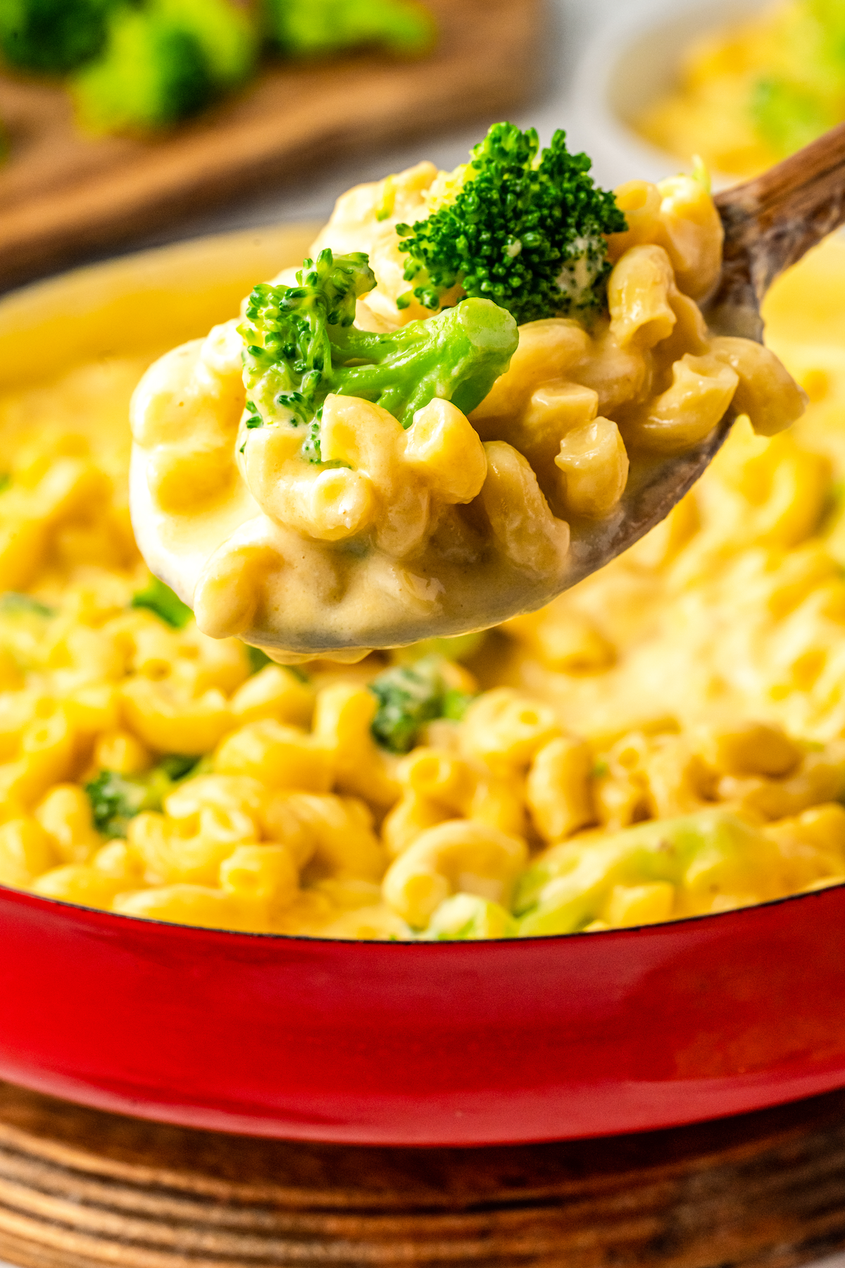 Spoonful of mac and cheese with broccoli.