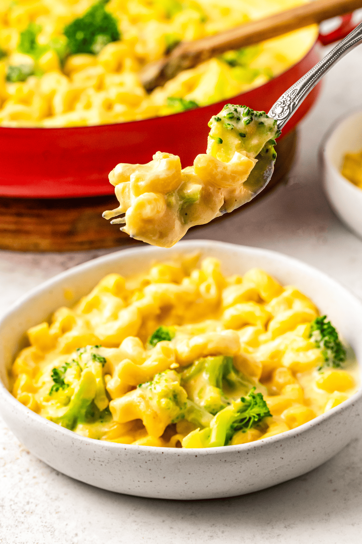 Forkful of macaroni and cheese with broccoli.