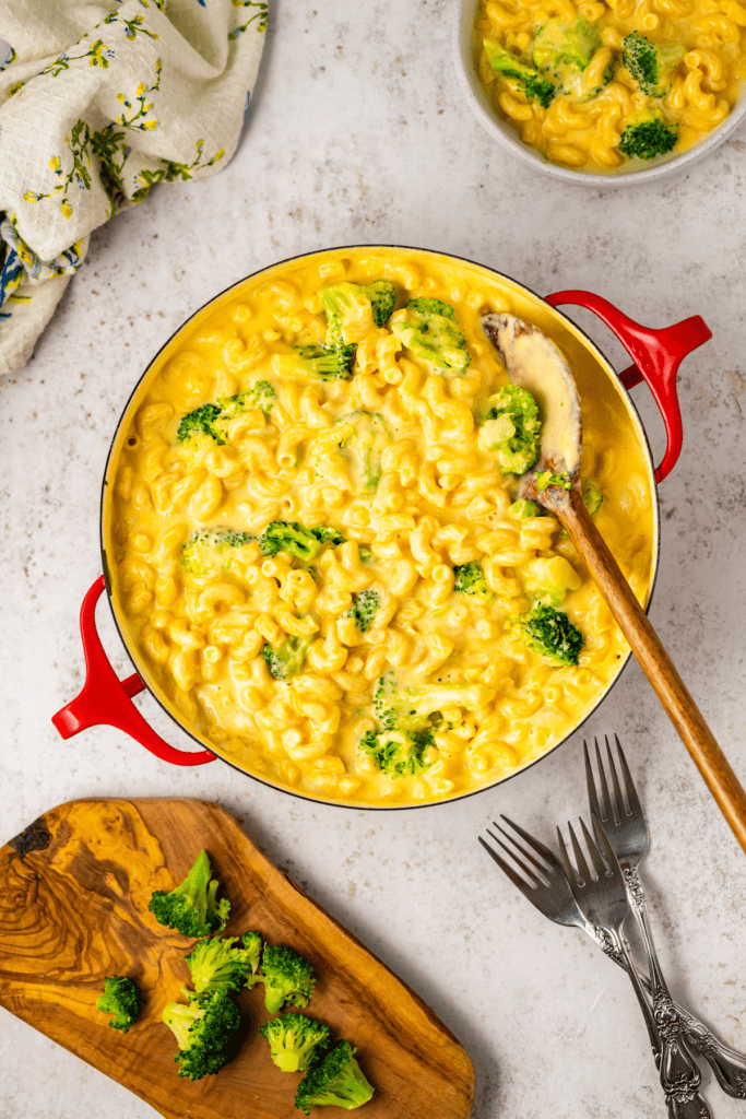 Mac and cheese with broccoli florets.