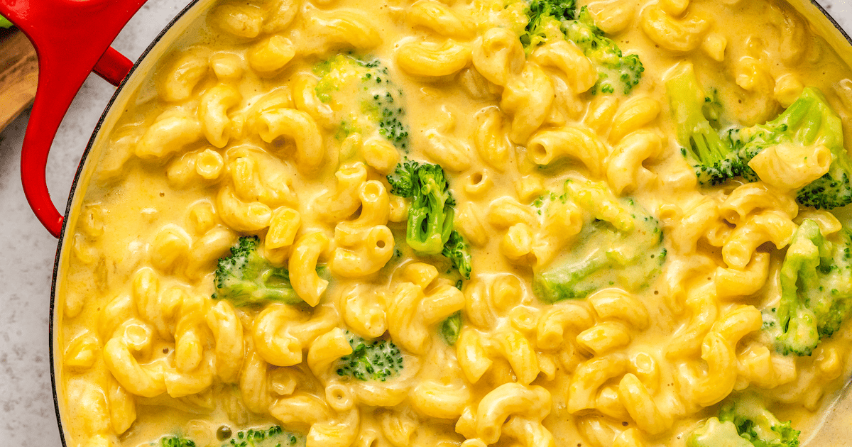 Cheddar mac and cheese with pieces of broccoli.