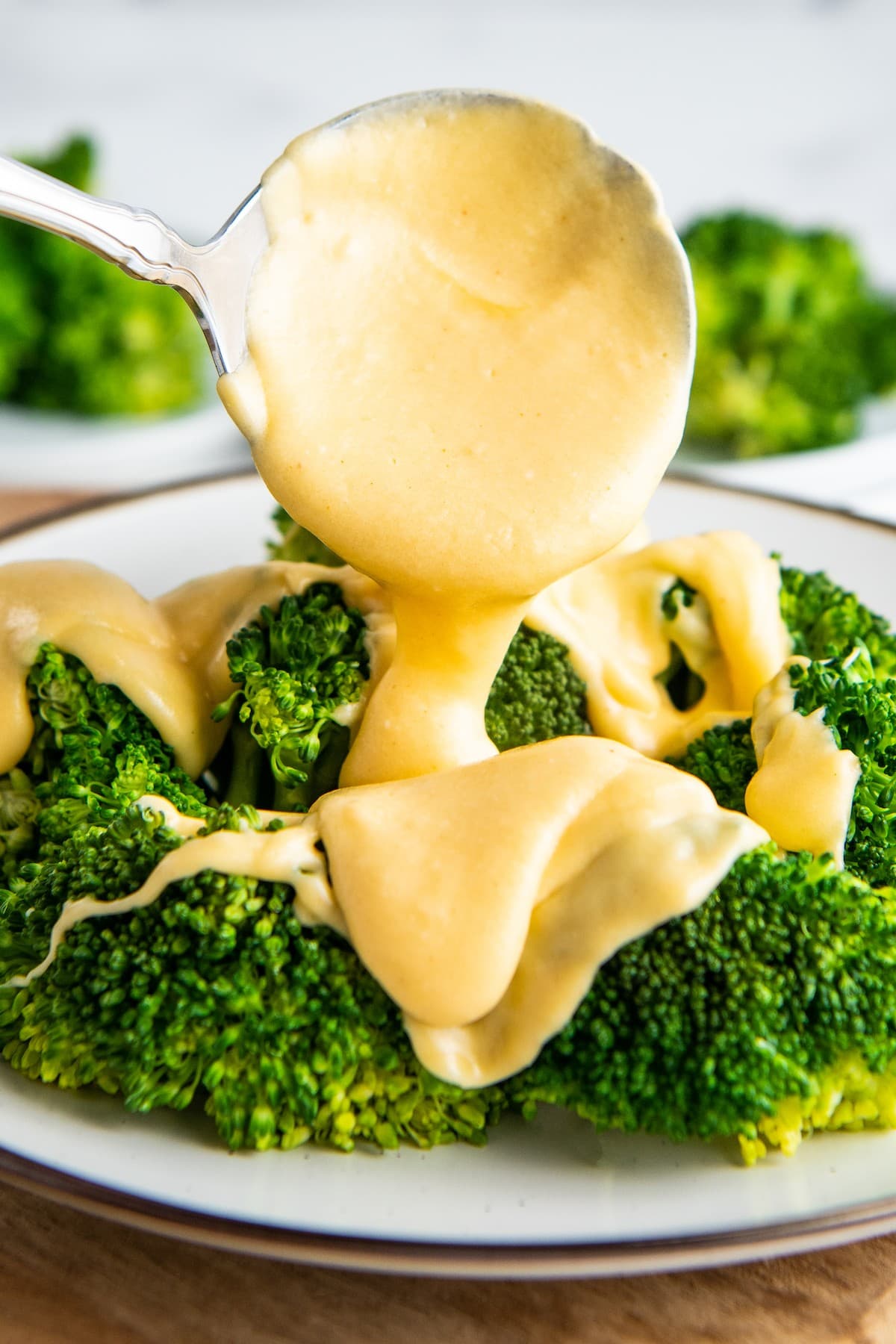 Cheese sauce poured over steamed broccoli.